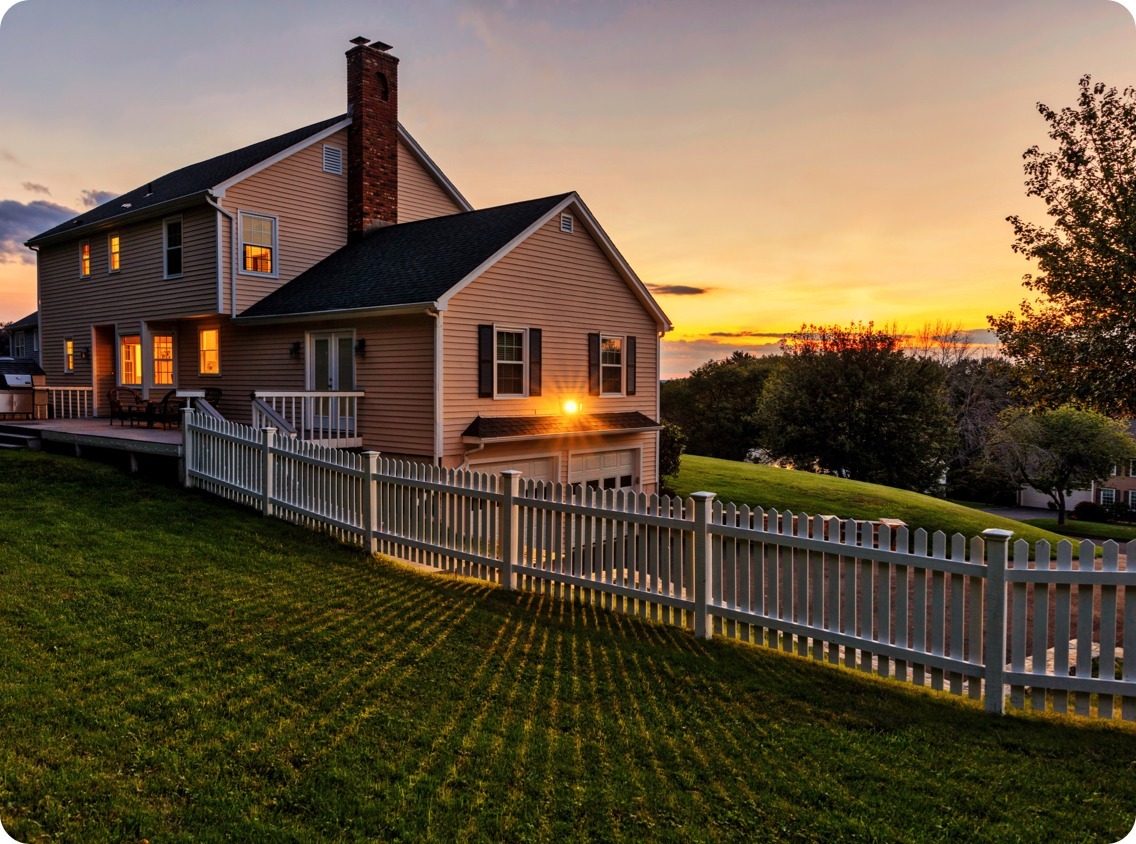 House with a fence at sunset